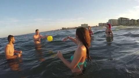 Friends having fun and playing volleyball in the sea Stock Footage 71996729