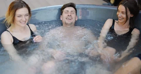 Friends having fun bathing at spa outdoors Stock Footage 154829979