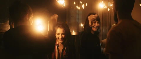 Friends having fun during new years eve playing with sparkler Stock Footage 202258189