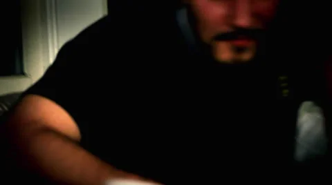 Friends having fun at a house party sit on a sofa and wave to the camera Stock Footage 33833072