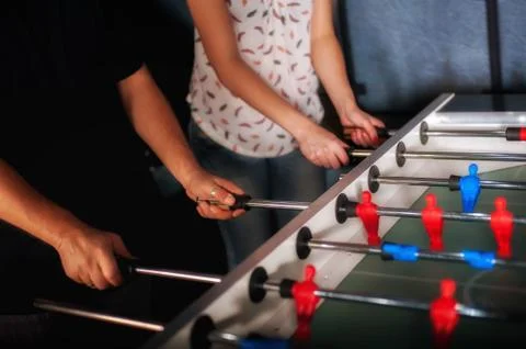 Friends having fun playing table foosball Stock Photos