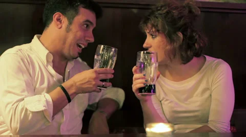 Friends having fun at pub. Smiling and happy friends with Glass of beer talking Stock Footage 32692729