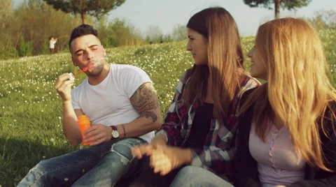 Friends having fun with soap bubbles Stock Footage 62776924