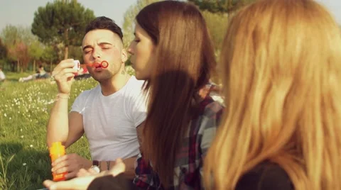 Friends having fun with soap bubbles Stock Footage 62776927