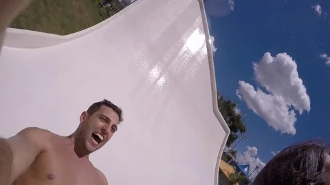 Friends having fun in water slide Stock Footage 72495524