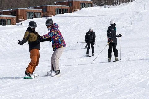 Friends Having Fun While Snowboarding in the Mountains. Stock Photos