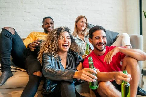 Friends having good time while watching a match together. Stock Photos