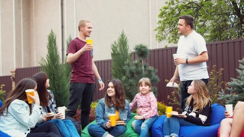 Friends having picnic in a garden Stock Footage 130059900