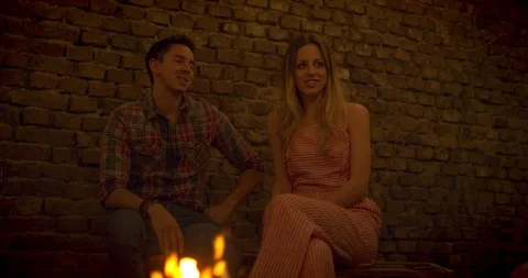 Friends having a talk at a fireplace Stock Footage 95327709
