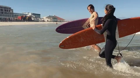 Friends high five after surfing Stock Footage 76521613