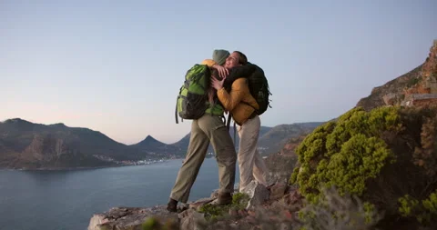 Friends, hiking and high five on mountain with hug, sea view or achievement for Stock Footage 332841653