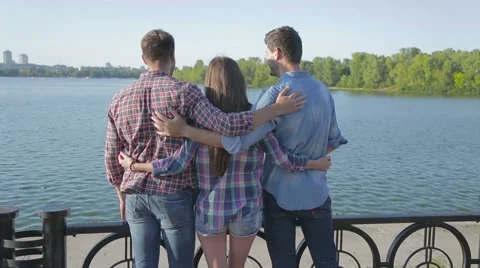 Friends hugging near river 53853473