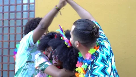 Friends hugging while at the carnival in the street Stock Footage 229700633