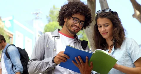 Friends interacting while reading books | Stock Video | Pond5