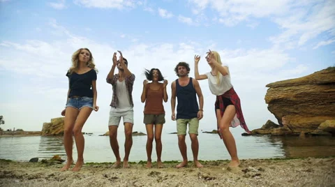 Friends jumping on the beach Stock Footage 68798505