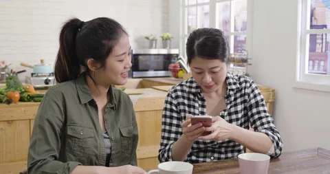Friends in kitchen taking selfie on mobile phone Stock Footage 133399545