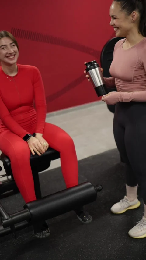 Friends laugh between workout sets Stock Footage 337956985