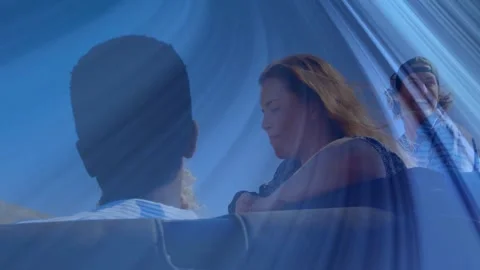 Friends leaning on railing beneath blue canopy highlighting tech design with Stock Footage 328252117