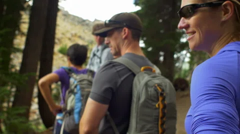Friends look around before continuing to hike Stock Footage 58965388