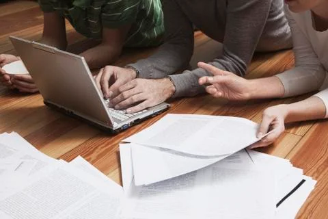 Friends lying on front using laptop. Stock Photos