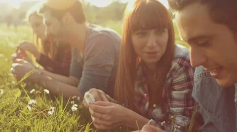 Friends lying on grass in the park Stock Footage 62777283