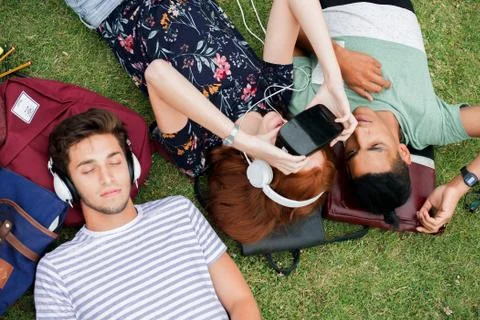 Friends lying on grass Stock Photos