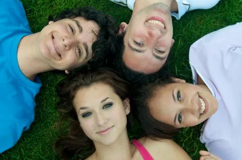 Friends lying on ground Stock Photos