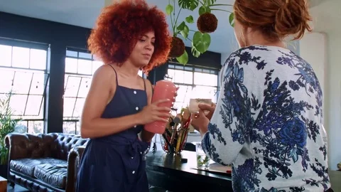 Friends making cocktails in trendy apartment Stock Footage