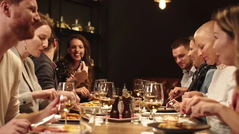 Friends making eating and making a toast in restaurant. Stock Footage 125073698
