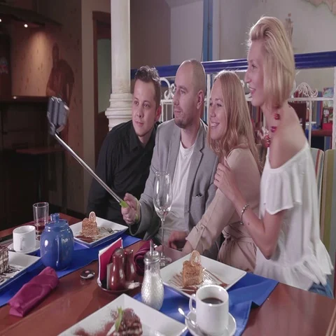 Friends making faces taking selfie in a restaurant 스톡 동영상 69282879