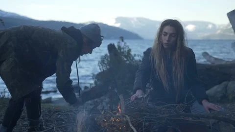 Friends making fire at the Lake Video stock 137597808
