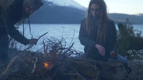 Friends making fire at the Lake Stock Footage 137597965