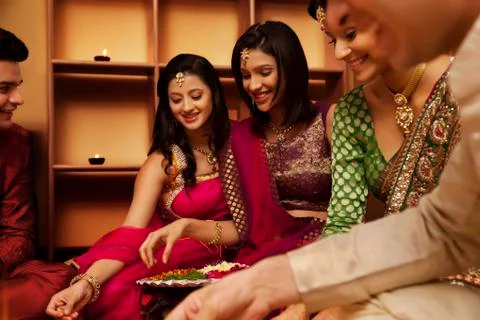Friends making a rangoli Stock Photos