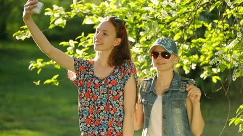 Friends making selfie. Two beautiful young women making selfie. Stock Footage 64129017