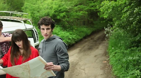 Friends outside camper van looking at map Video stock 60950994