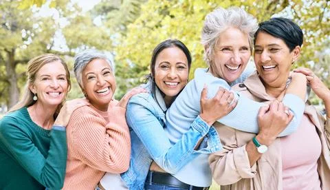Friends, park and group of women hug enjoying bonding, quality time and relax in Stock Photos