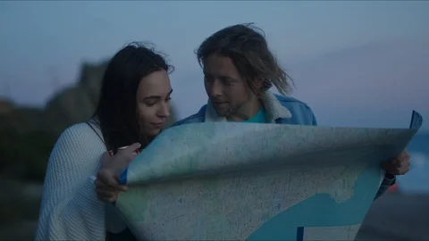 Friends plan out route in a map, chill evening at west coast Vidéo 127409693