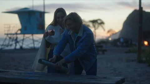 Friends plan out route in a map, chill evening at west coast Stock-Footage 127409701