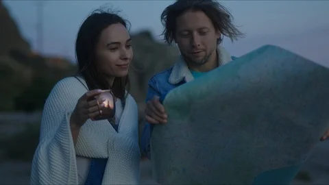 Friends plan out route in a map, chill evening at west coast Видео 127409706