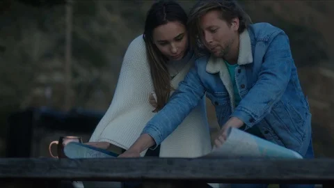 Friends plan out route in a map, chill evening at west coast Stock-Footage 127409722