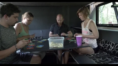 Friends Play with Cards Camping in 5th Wheel Stock Footage 80540109