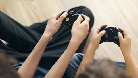 Friends play computer console press joystick buttons, top view, hands only Stock Footage 168391827