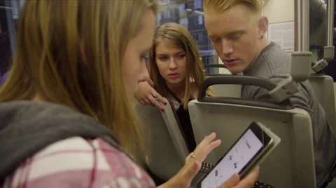 Friends play with iPad on max train Stock Footage 54262131
