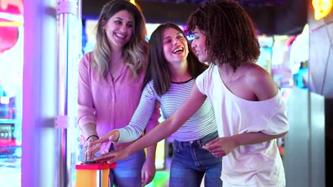 Friends playing arcade game together in summer Stock Footage 311798666
