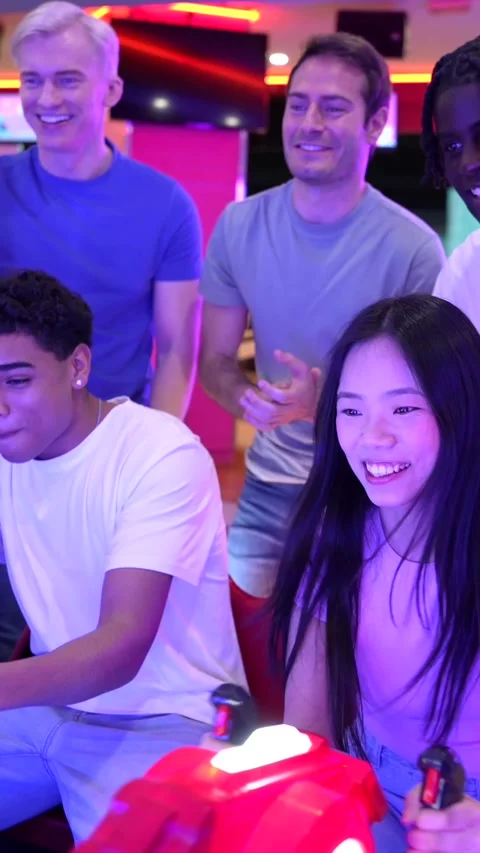 Friends playing arcade games at bowling alley Stock Footage 308262291