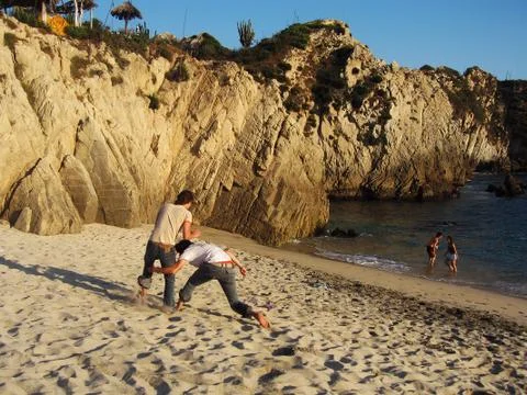 Friends playing on the beach Foto stock