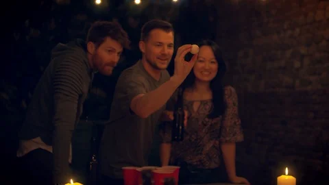 Friends playing beer pong Stock Footage 103153149