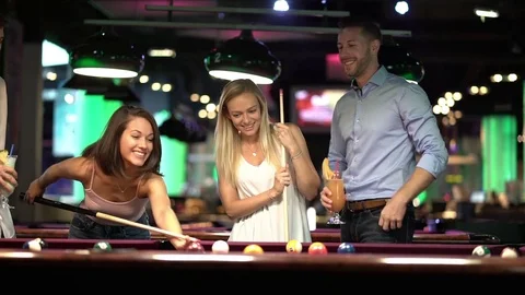 Friends playing billiard together Stock Footage