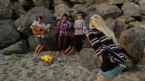 Friends playing by the campfire Stock Footage 62345286