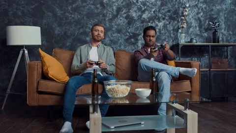 Friends Playing Console Games at Home. Friends at Couch. Gamers at Home. Shot on Stock Footage 217869512